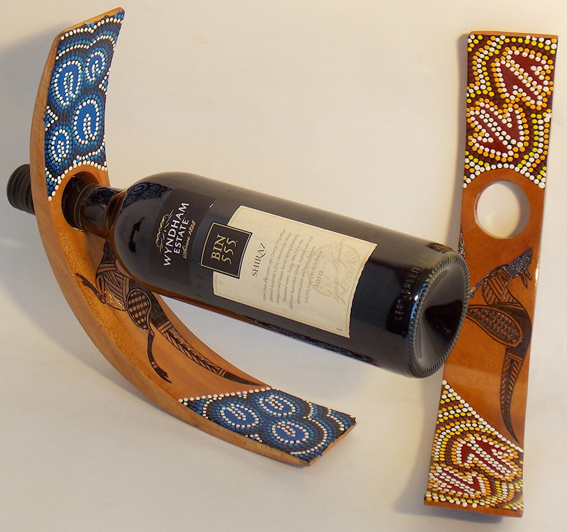 C-shaped wine bottle holders decorated in Aboriginal traditional dot art style 